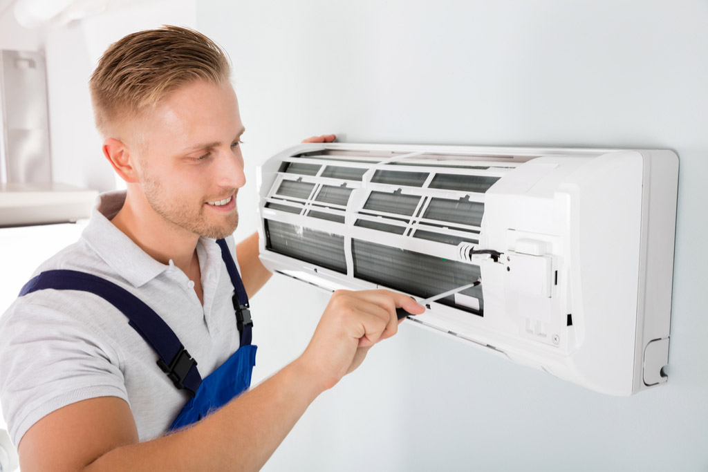 HVAC technician maintaining a ductless air conditioner in Windsor