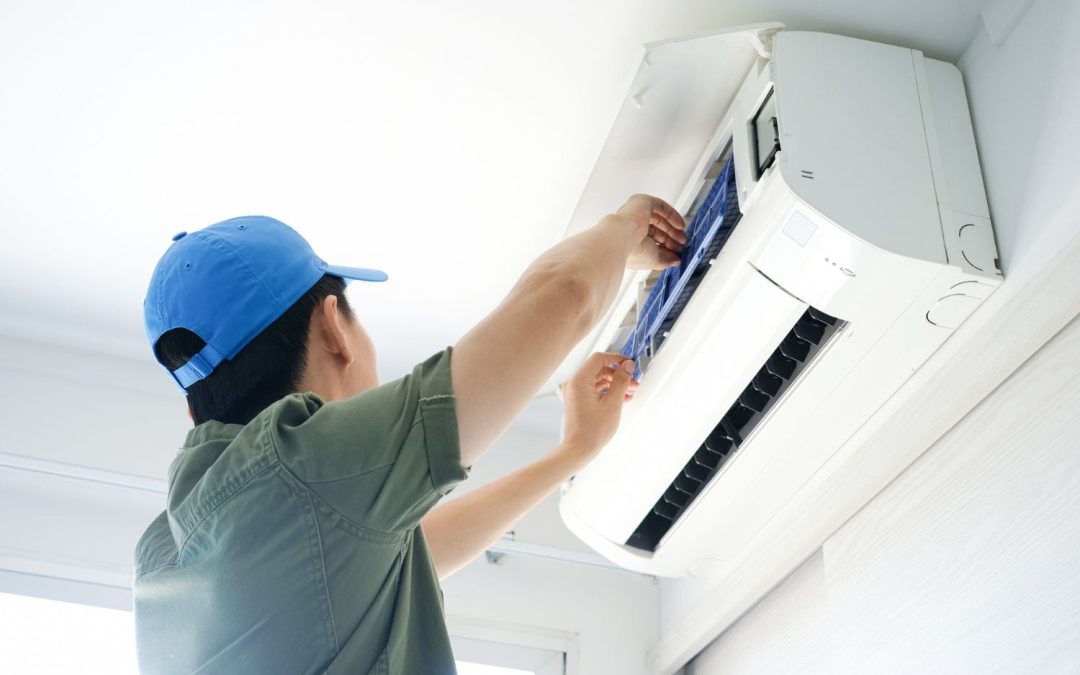 HVAC technician servicing a ductless mini split in Windsor