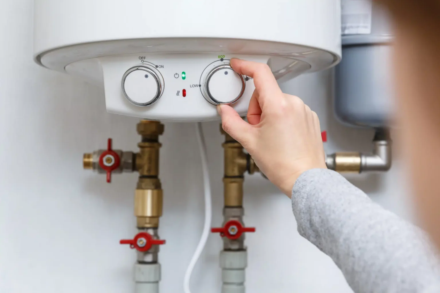 Technician adjusting a water heater in Windsor